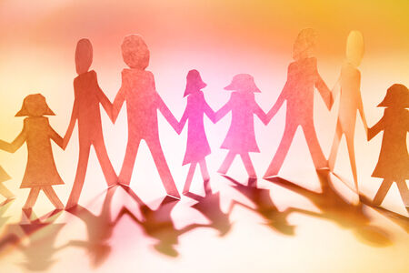 paper cut out of family figures holding hands