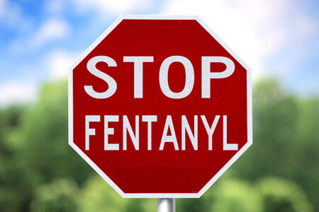 Stop Fentanyl on a Stop Sign in Front of Trees in the Background.